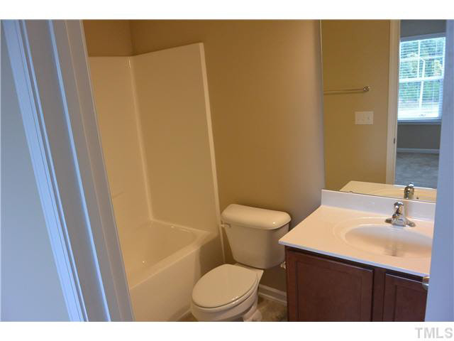 5009 Lalex Lane Cary, NC 27519 - Photo 15 of 15 a bathroom with a sink and a mirror