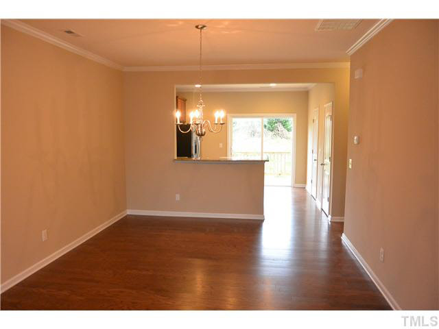 5009 Lalex Lane Cary, NC 27519 - Photo 3 of 15 a view of a hallway with wooden floor and a living room