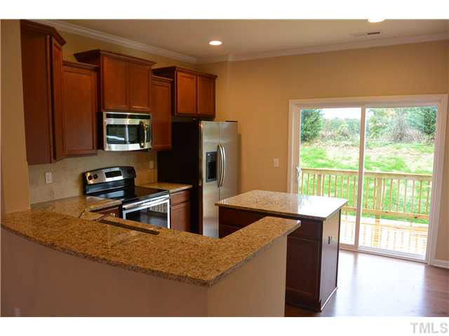5009 Lalex Lane Cary, NC 27519 - Photo 4 of 15 a kitchen with stainless steel appliances granite countertop a sink a stove and refrigerator