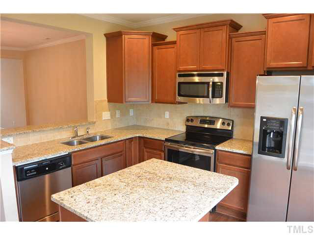 5009 Lalex Lane Cary, NC 27519 - Photo 5 of 15 a kitchen with stainless steel appliances granite countertop a refrigerator stove top oven