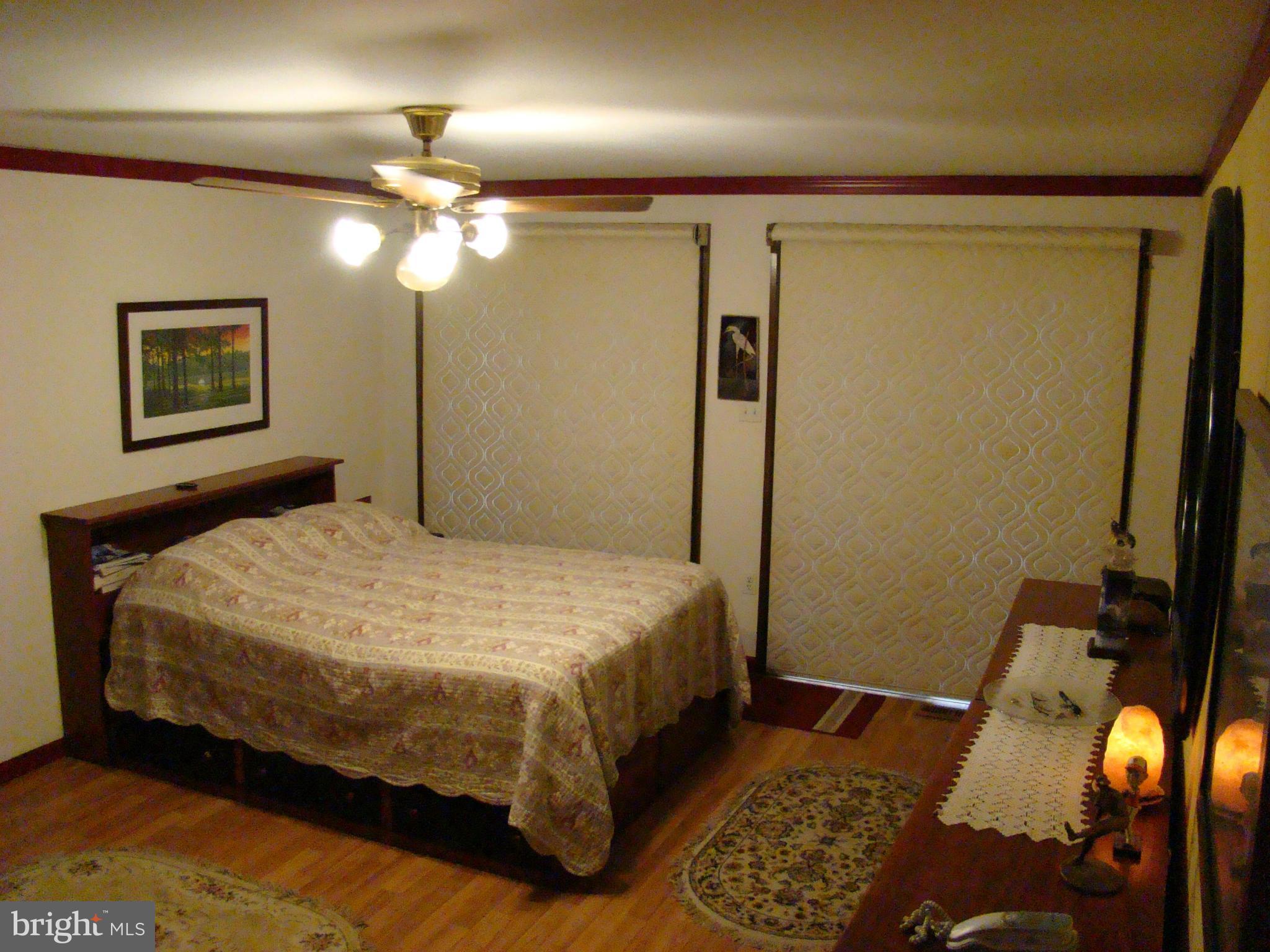 3100 Ross Road St. Leonard, MD 20685 - Photo 12 of 23 a bedroom with a bed and a mirror