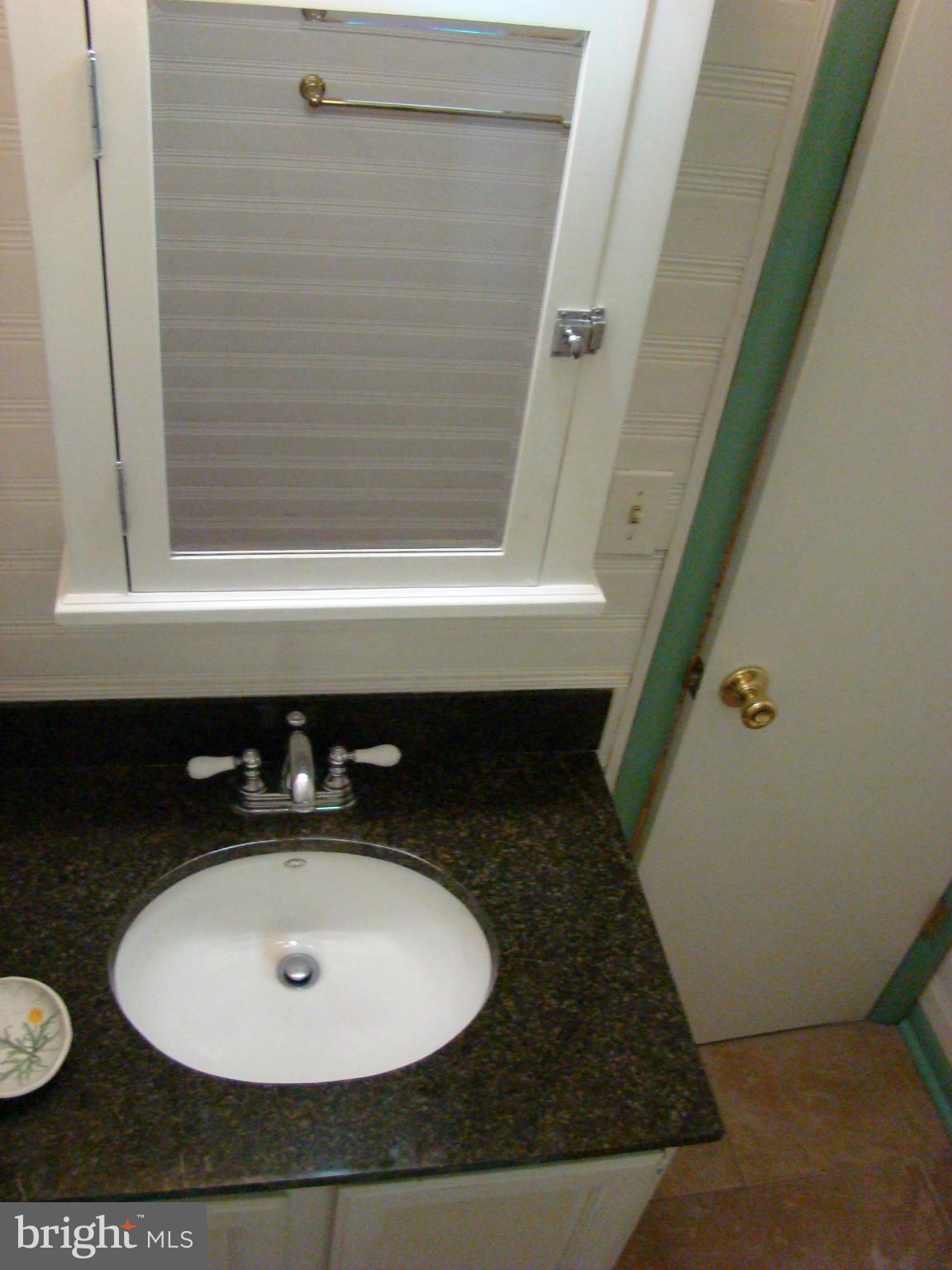 3100 Ross Road St. Leonard, MD 20685 - Photo 14 of 23 a bathroom with a sink and a mirror