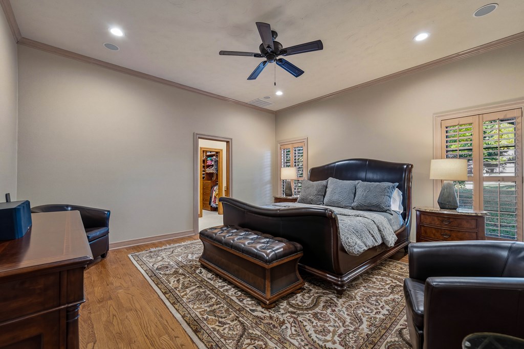 2409 West Commerce Street San Saba, TX 76877 - Photo 23 of 96 a spacious bedroom with a bed a couch and a window