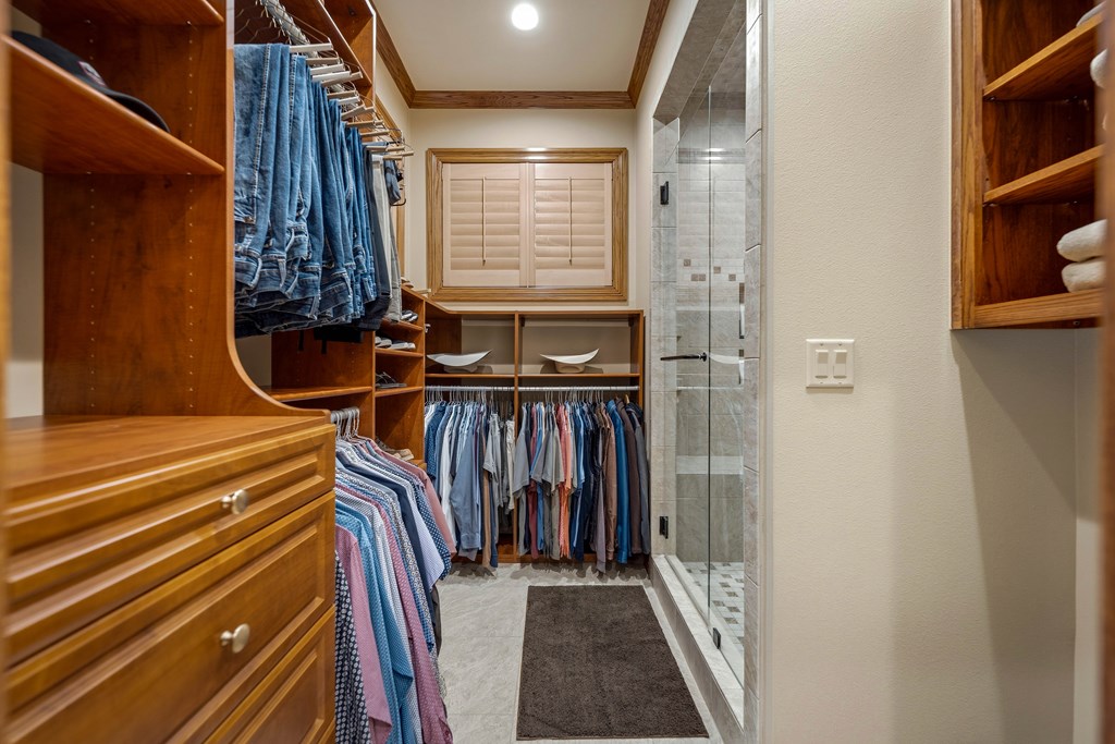 2409 West Commerce Street San Saba, TX 76877 - Photo 26 of 96 a view of walk in closet with clothes and shoes