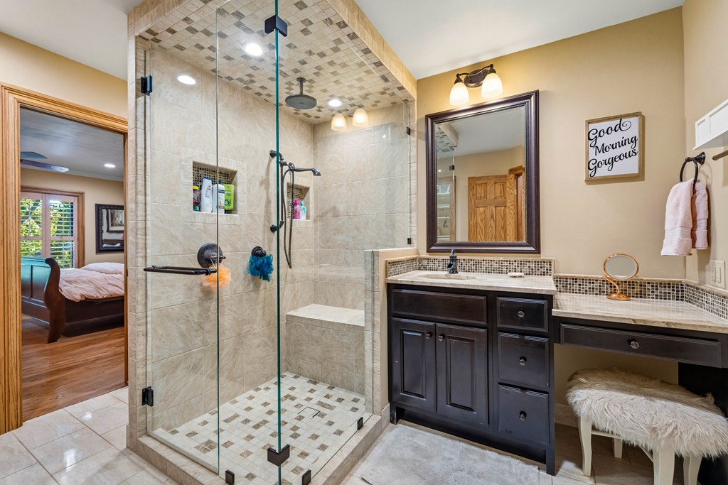 2409 West Commerce Street San Saba, TX 76877 - Photo 41 of 96 a en suite bathroom with a double vanity sink and a mirror