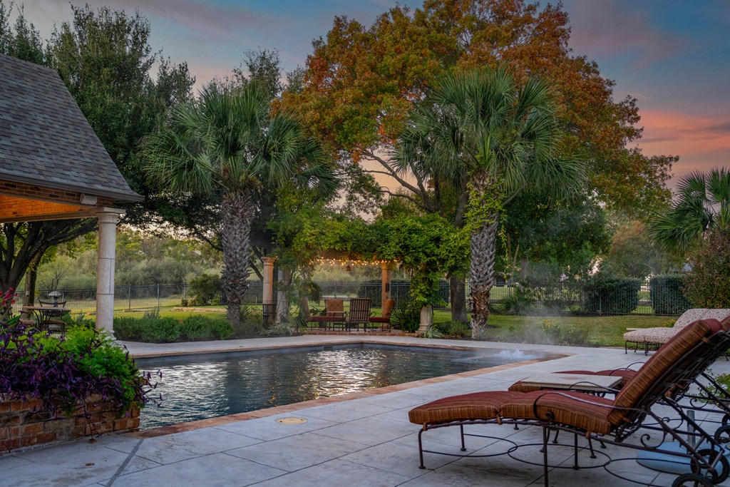 2409 West Commerce Street San Saba, TX 76877 - Photo 48 of 96 a view of a swimming pool with a patio and a yard