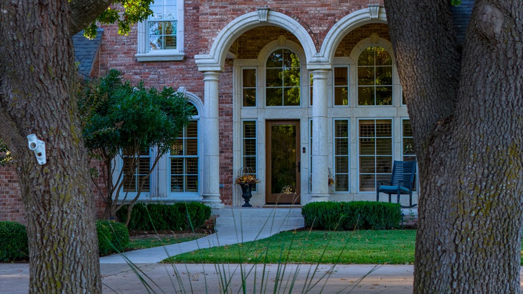 2409 West Commerce Street San Saba, TX 76877 - Photo 72 of 96 a view of a brick house with a yard plants and large tree