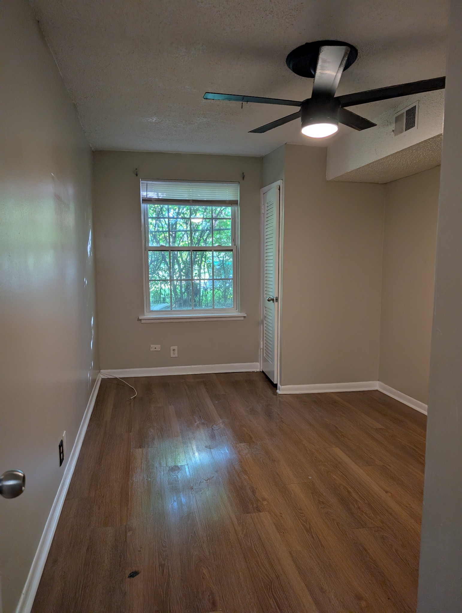 441 Harding Place, Unit B2 Nashville, TN 37211 - Photo 5 of 12 an empty room with wooden floor fan and windows