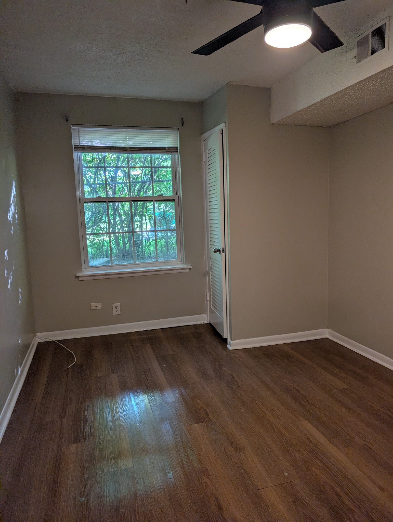 441 Harding Place, Unit B2 Nashville, TN 37211 - Photo 6 of 12 an empty room with wooden floor and windows