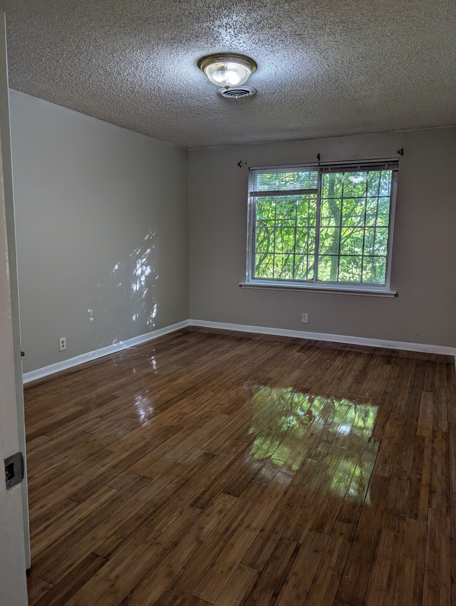 441 Harding Place, Unit B2 Nashville, TN 37211 - Photo 7 of 12 an empty room with wooden floor and windows