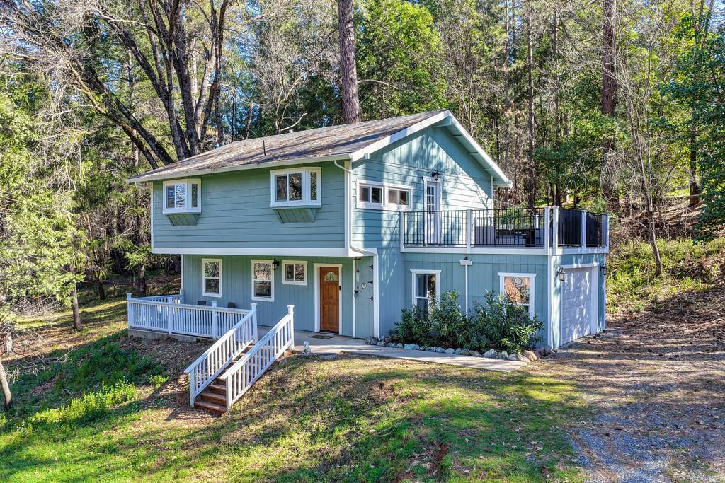 3191 Fort Jim Road Placerville, CA 95667 - Photo 1 of 30 a front view of a house with a yard table and chairs