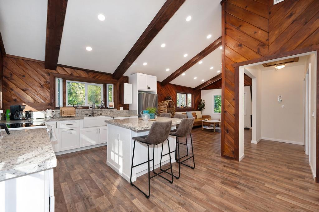 3191 Fort Jim Road Placerville, CA 95667 - Photo 17 of 30 a kitchen with stainless steel appliances granite countertop wooden cabinets a dining table and chairs
