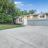 a view of backyard of house with green space