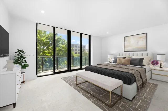 a bedroom with a large bed and a large window