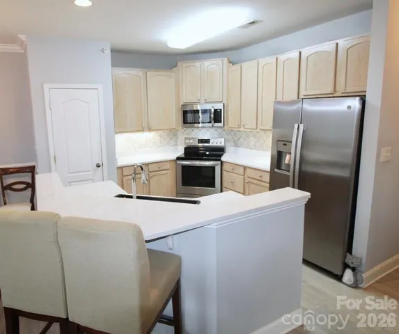 a kitchen with cabinets and stainless steel appliances