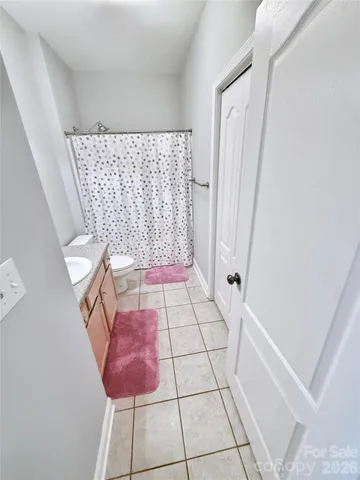 a bedroom with a bed and a flat tv screen on dresser