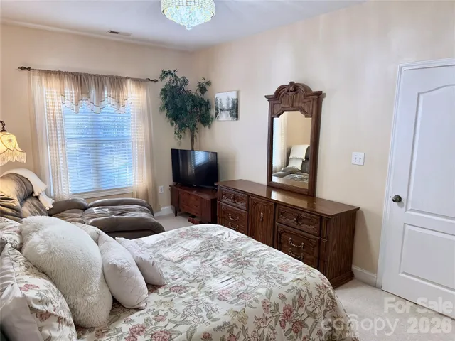 a bathroom with a granite countertop sink mirror vanity and toilet