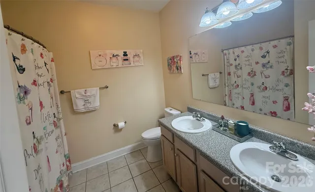 a view of a hallway with a ceiling fan and window