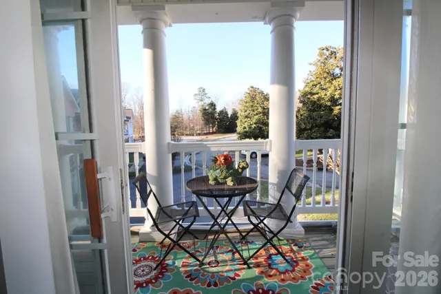 a view of a chairs and table in a balcony