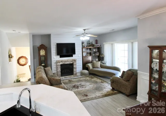 a living room with fireplace furniture and a flat screen tv