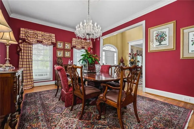 a view of a dining room with furniture and chandelier