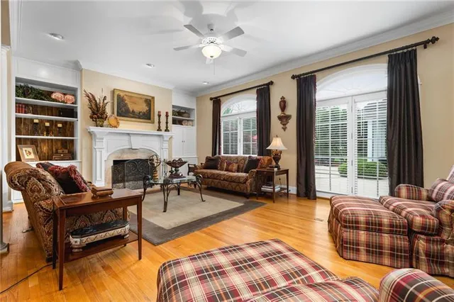 a living room with furniture fireplace and a large window