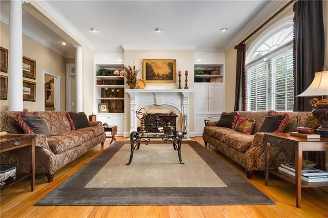 a living room with furniture and a fireplace