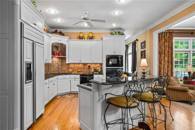 a kitchen with granite countertop a sink and cabinets