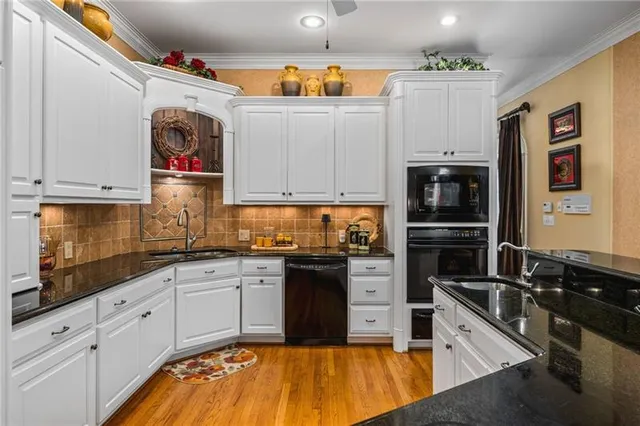a kitchen with stainless steel appliances granite countertop a sink and cabinets