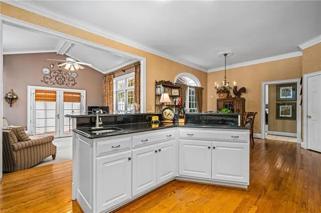 a view of a dining room with furniture wooden floor and chandelier