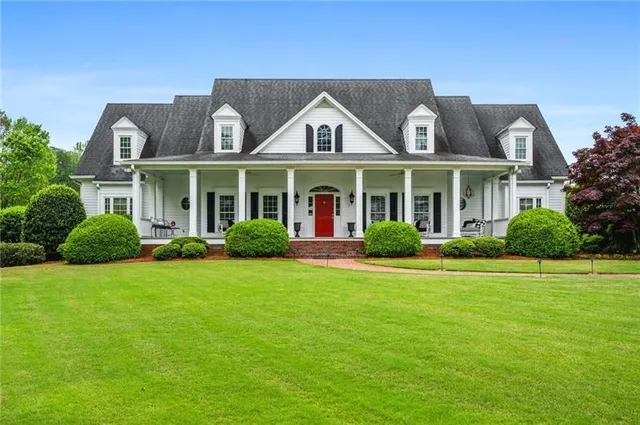 a front view of a house with a garden
