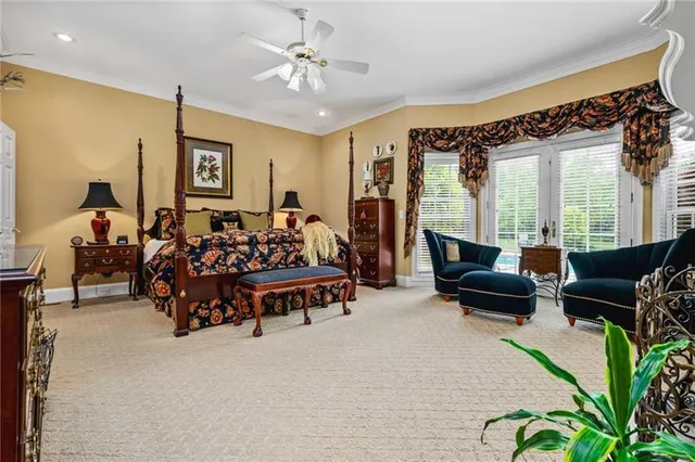 a bedroom with a bed and a chandelier