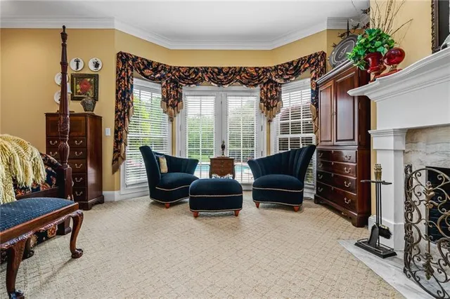 a bedroom with a bed table chair and a window