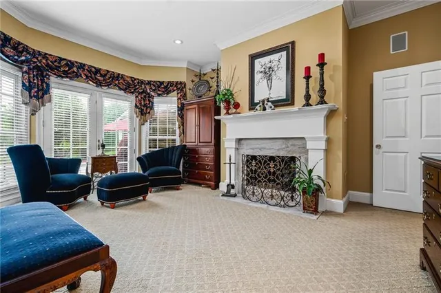 a bedroom with a bed chair and a large window