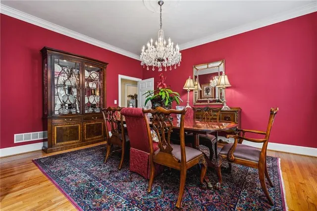 a view of a dining room with furniture and chandelier