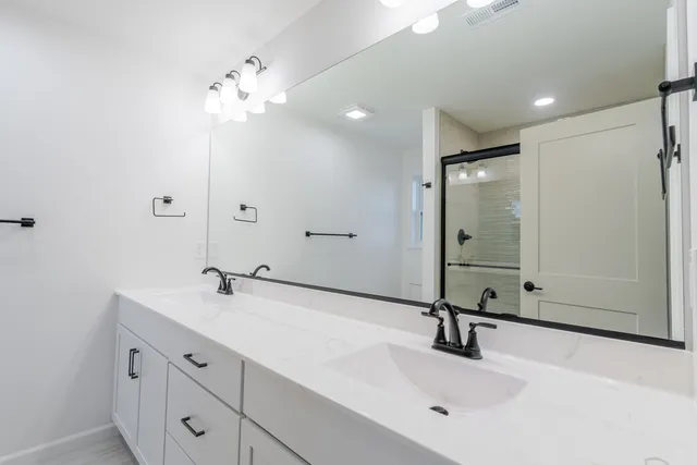 a bathroom with a sink double vanity and a mirror