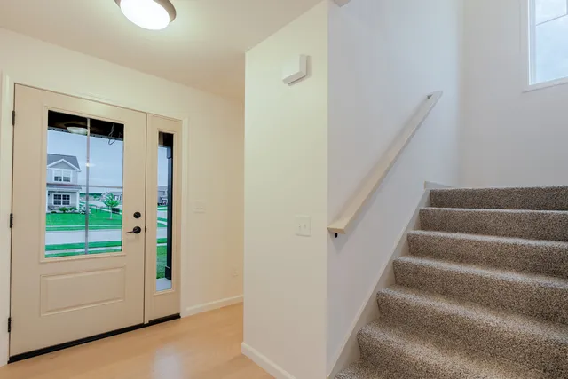 a view of staircase with lots of frames on wall
