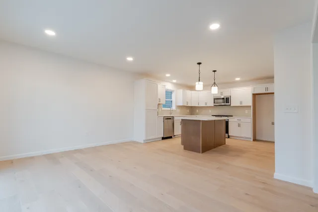 a kitchen with a sink wooden cabinets and counter top space