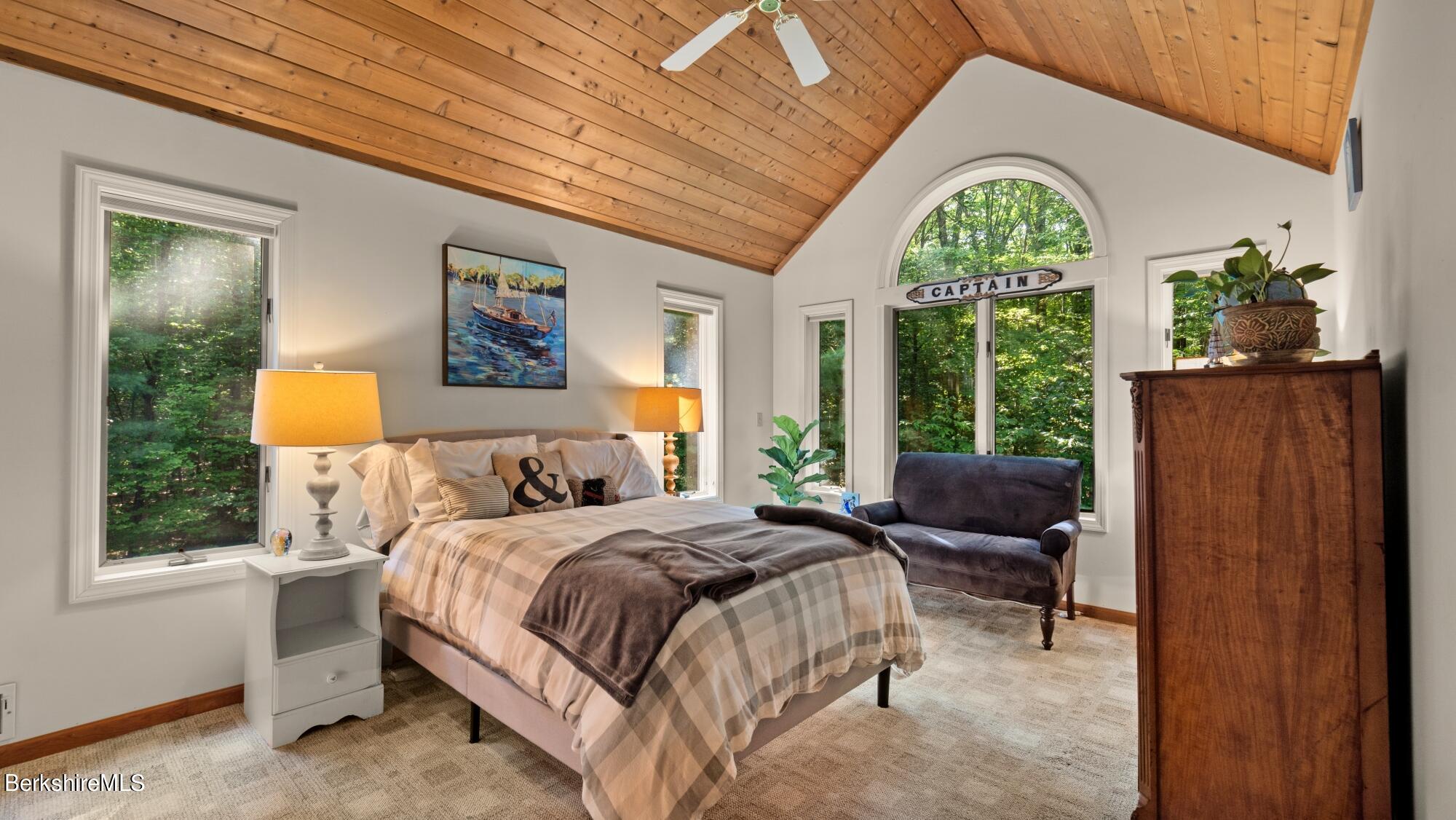 499 Norton Road Otis, MA 01029 - Photo 20 of 31 a spacious bedroom with a bed a dresser next to a window