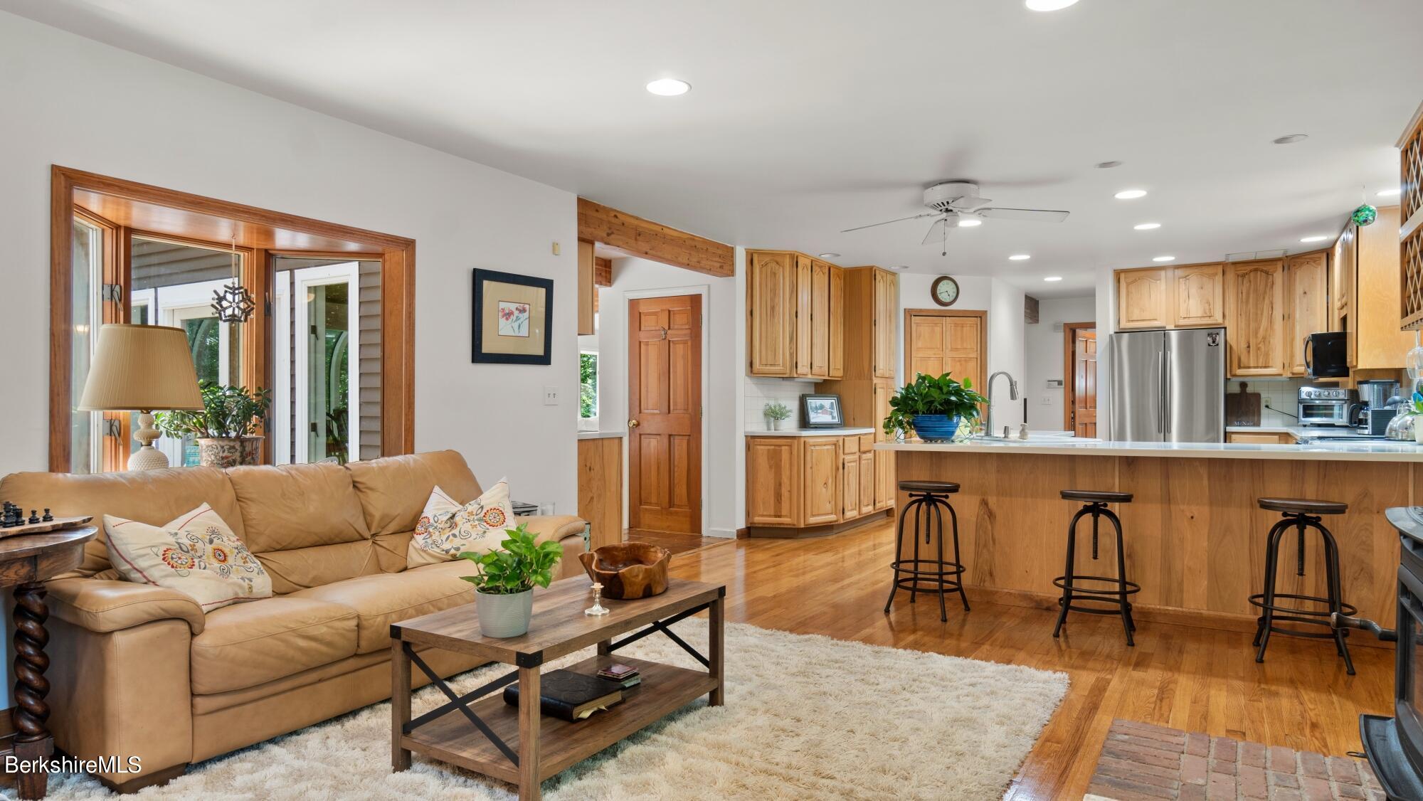 499 Norton Road Otis, MA 01029 - Photo 6 of 31 a living room with furniture a wooden floor and kitchen view