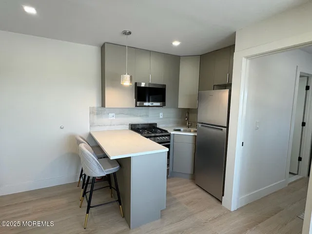 a kitchen with a refrigerator a table and chairs