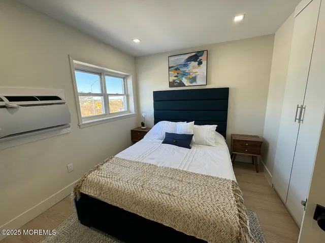 a bed sitting in a bedroom next to a window