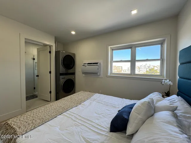 a bedroom with a large bed and a large window