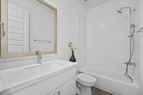 a bathroom with a sink a toilet and a bathtub