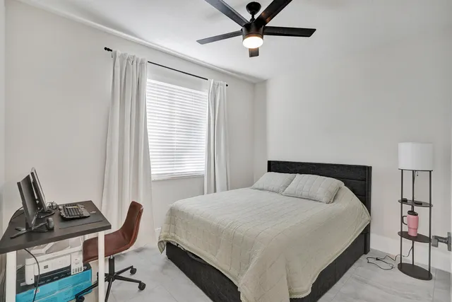 a bedroom with a bed and a window