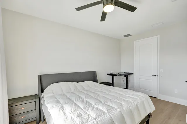 a bedroom with a bed and a dresser