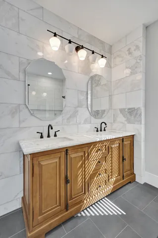 a bathroom with a granite countertop sink and a mirror