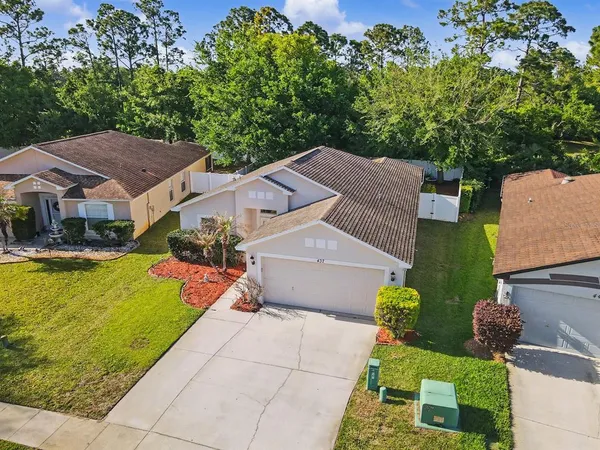 an aerial view of a house with swimming pool and porch