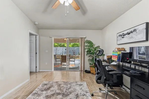 a view of a workspace with furniture and a window