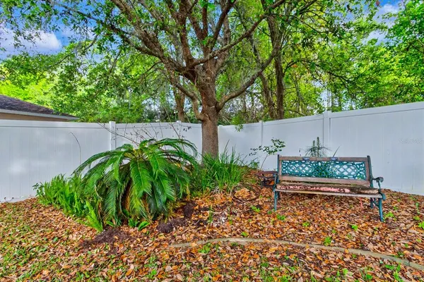 a backyard of a house with table and chairs